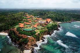 Tropical resort complex built on a headland, surrounded by dense jungle and two small beaches in Sri Lanka